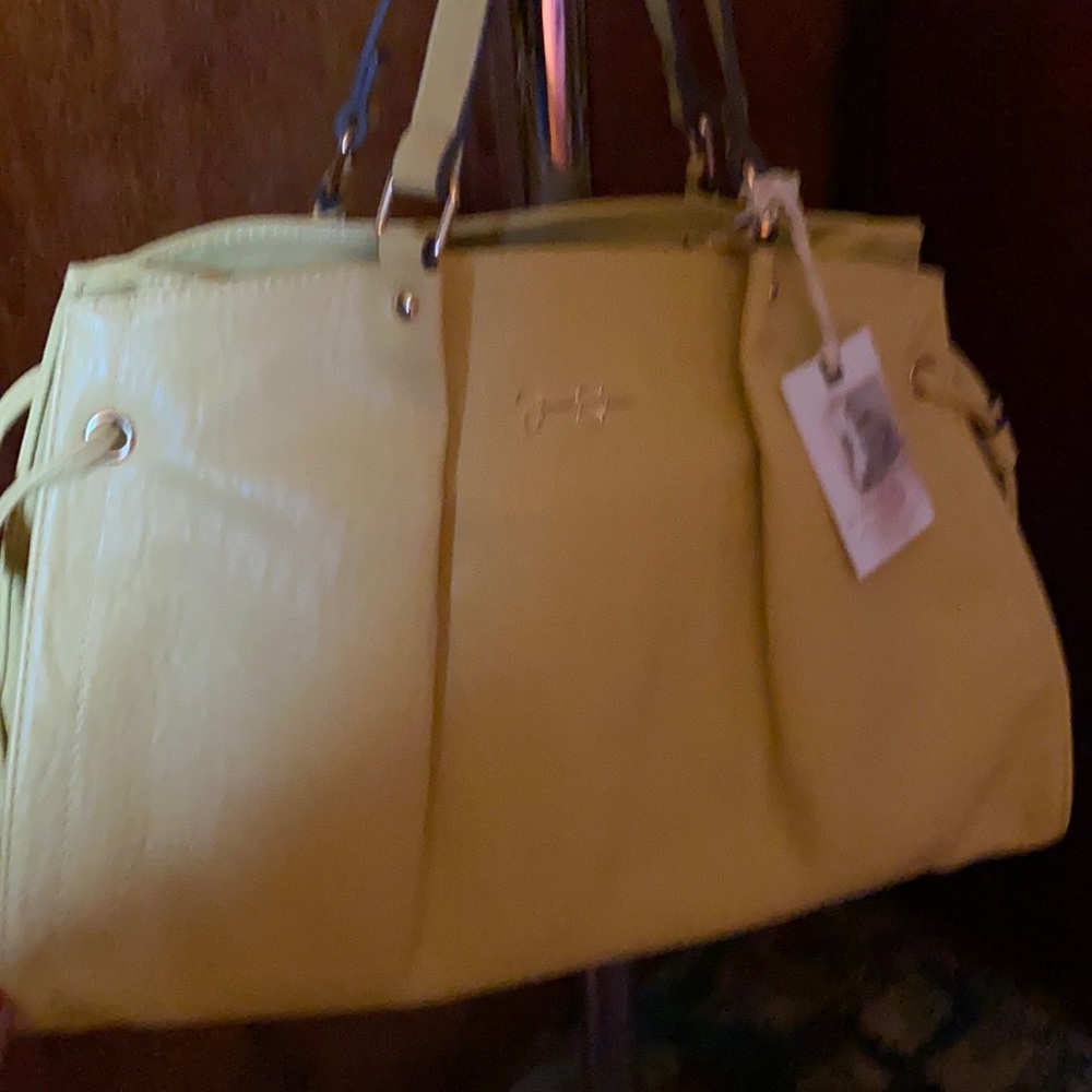 Yellow. Jessica Simpson. Lots of compartments. New w/ tag.